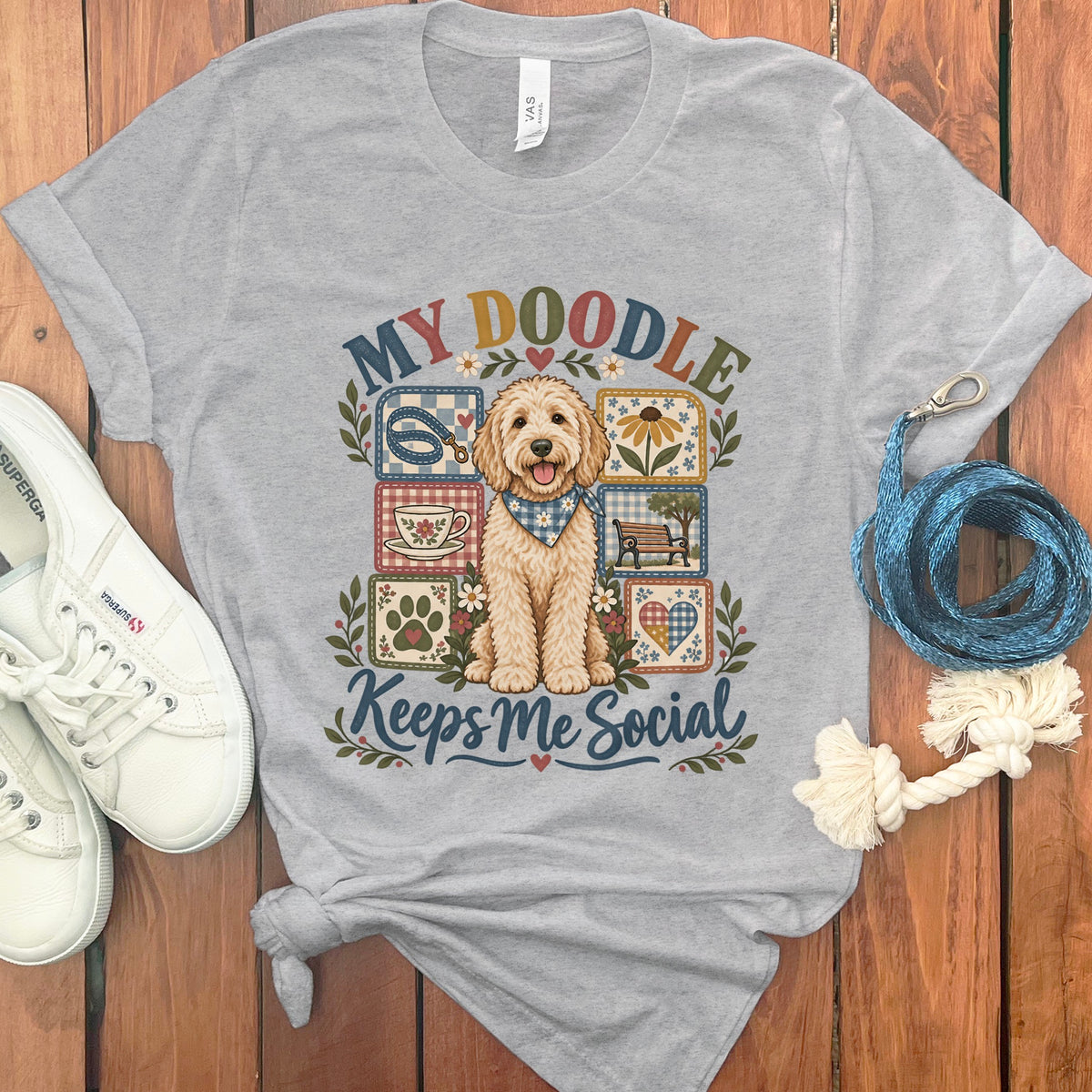 Gray t-shirt with a doodle dog graphic saying "My Doodle Keeps Me Social".