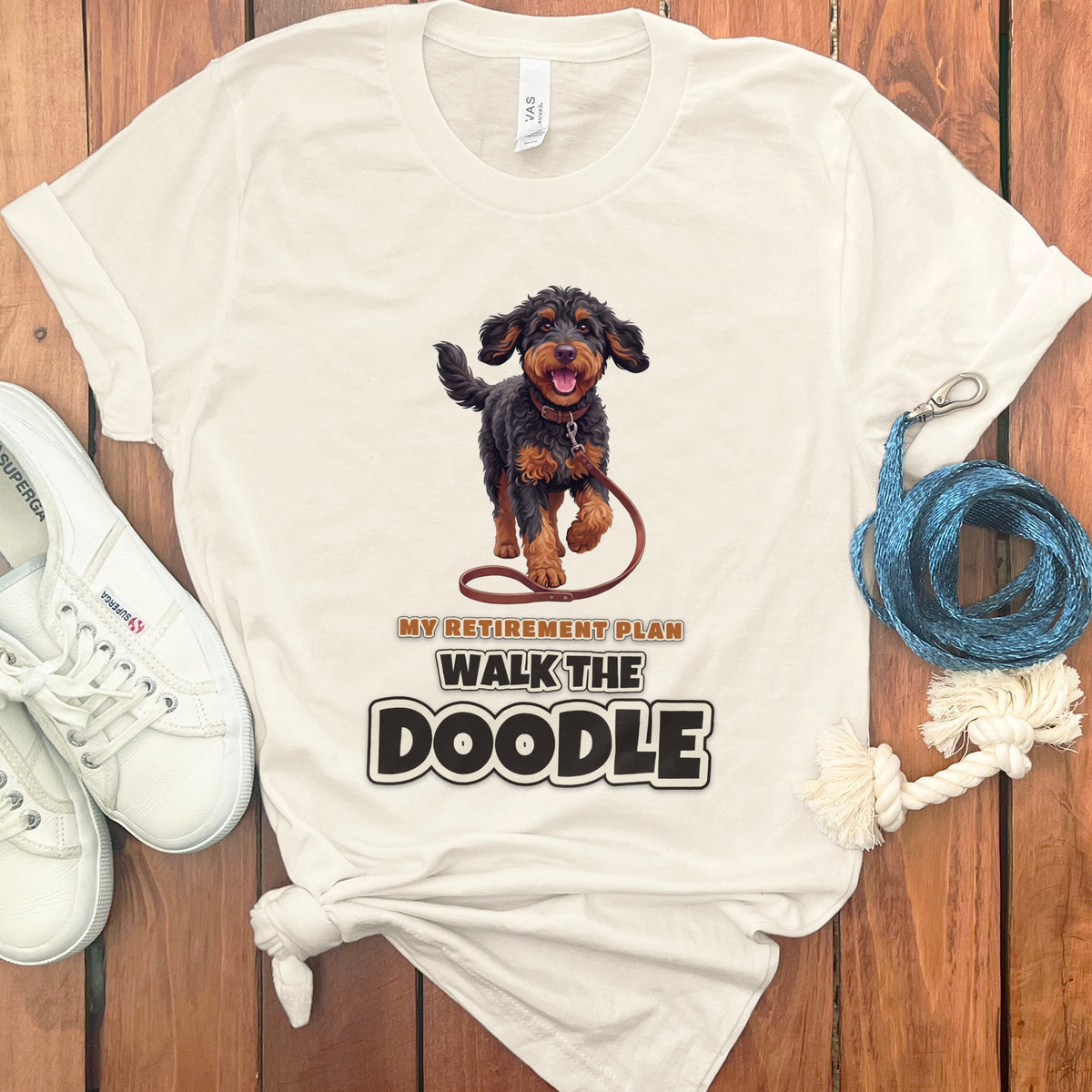 Cream t-shirt with a doodle graphic and text "MY RETIREMENT PLAN WALK THE DOODLE".