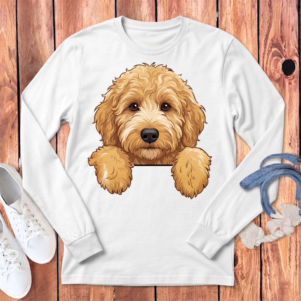White long-sleeve shirt with a cartoon doodle dog graphic over a wood background.