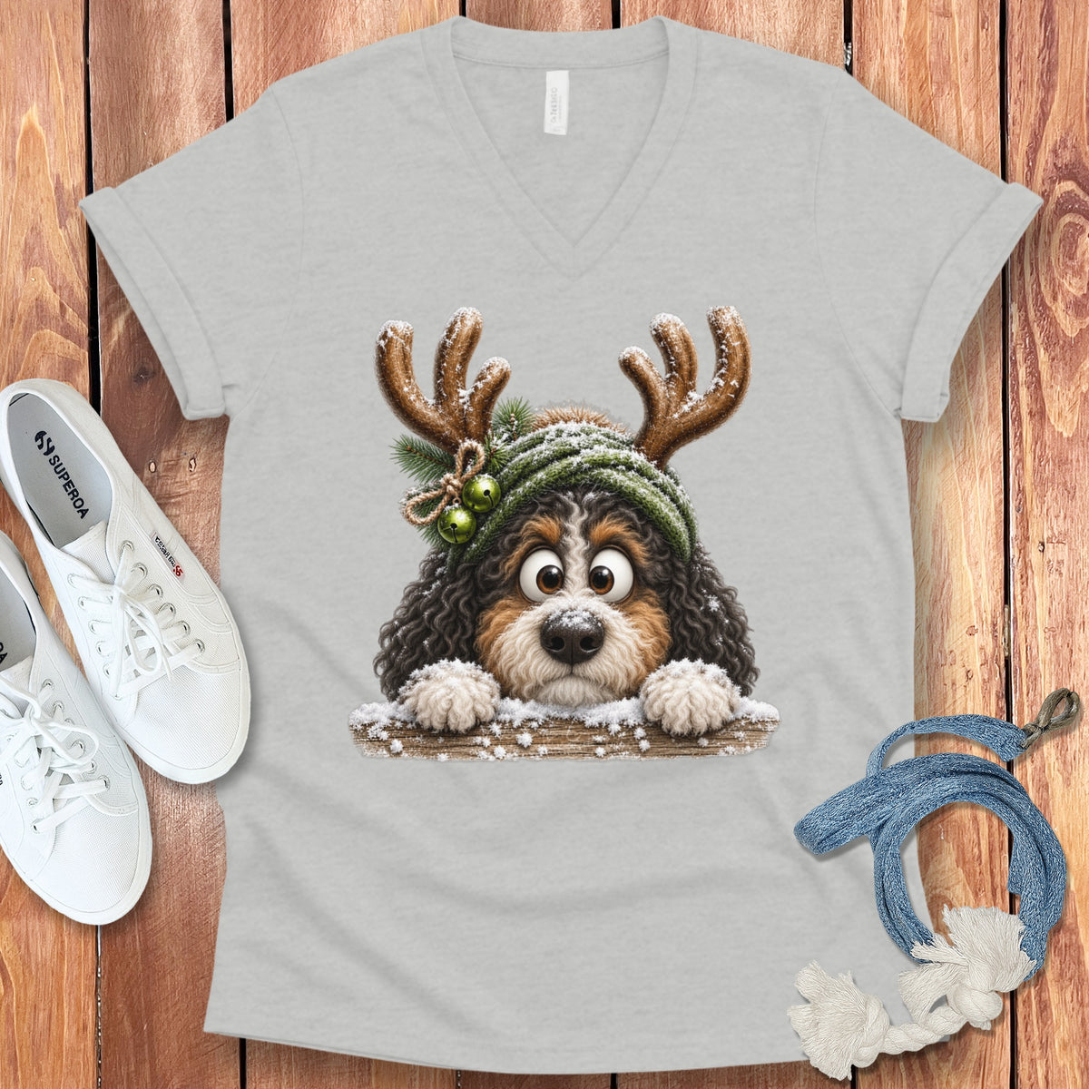 Light grey t-shirt with a cute dog wearing reindeer antlers and green hat.