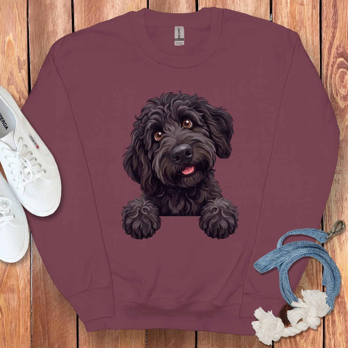 Burgundy sweatshirt with a black doodle dog illustration and white sneakers.