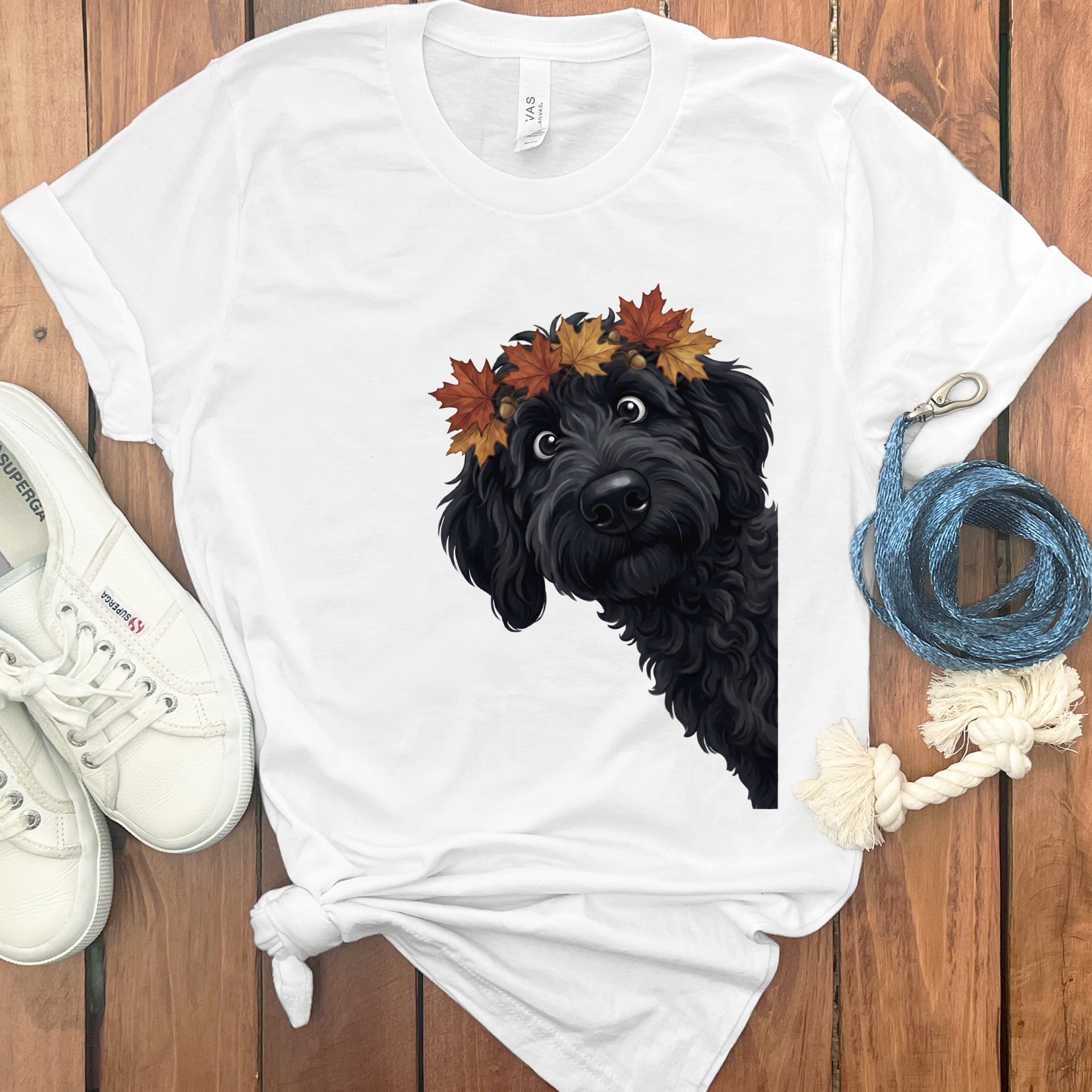 White t-shirt with black dog wearing autumn leaves wreath and surprised expression