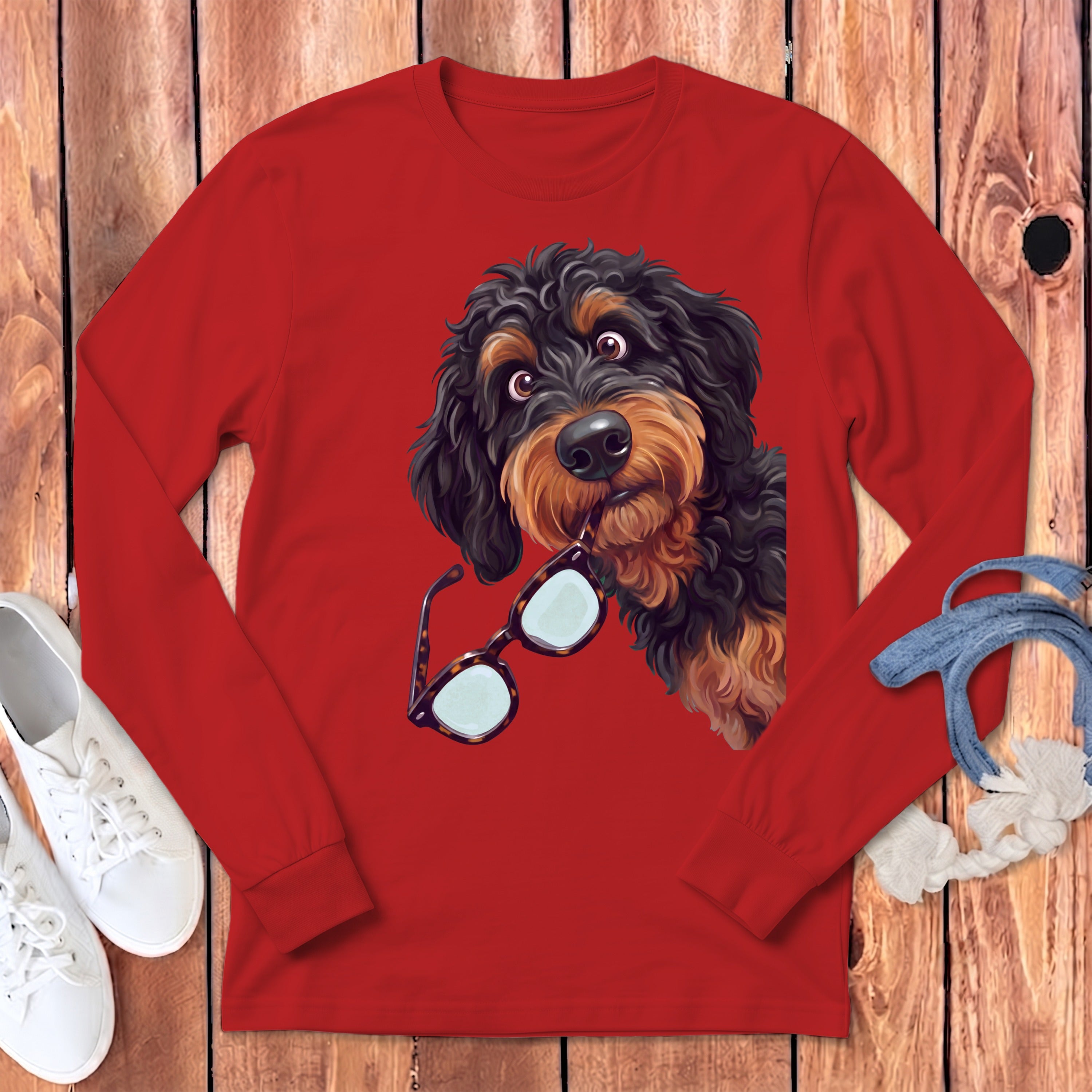 Bright red long-sleeved shirt featuring a graphic of a shaggy black and brown dog holding glasses in its mouth.