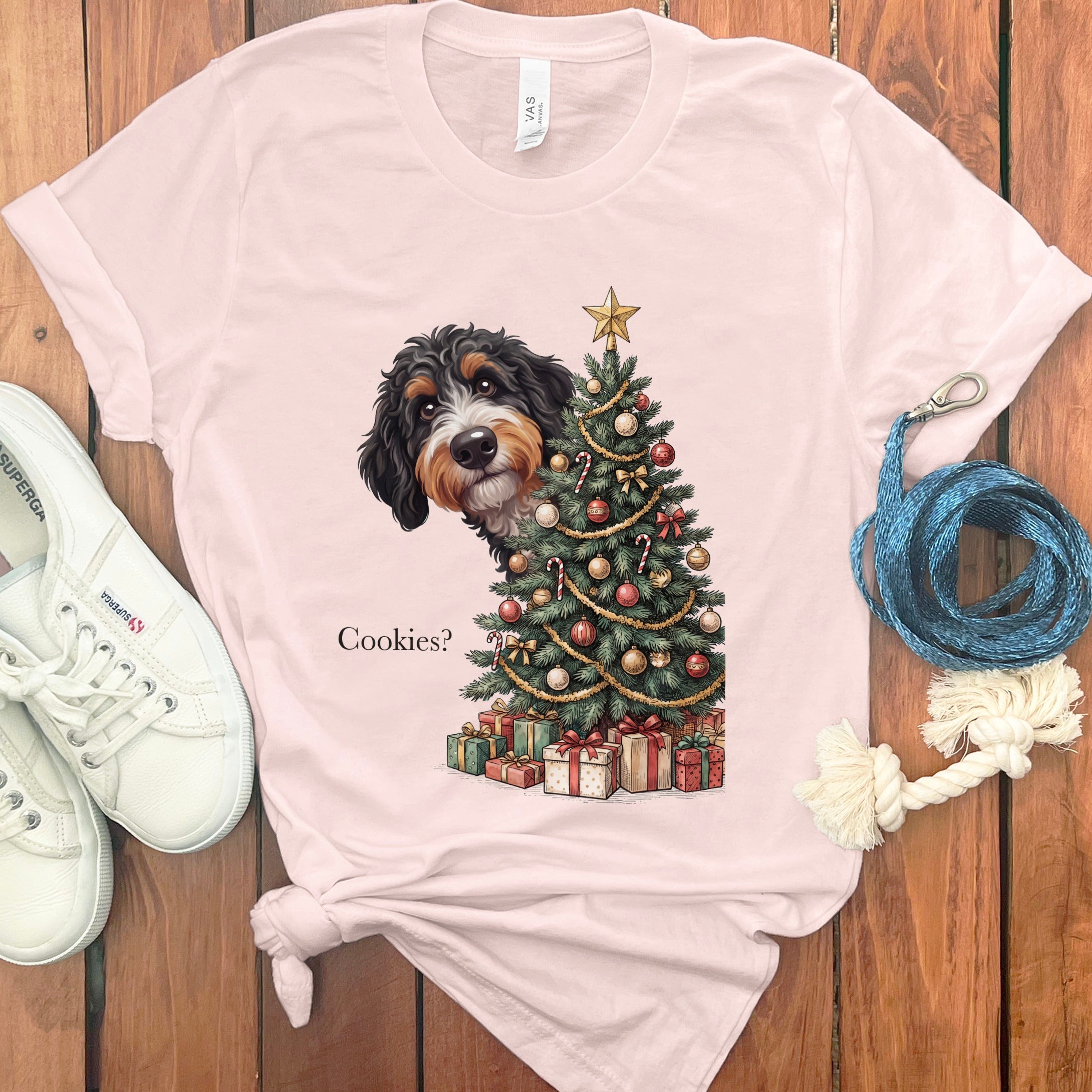 Bernese Mountain Dog peeks from behind Christmas tree asking "Cookies?".