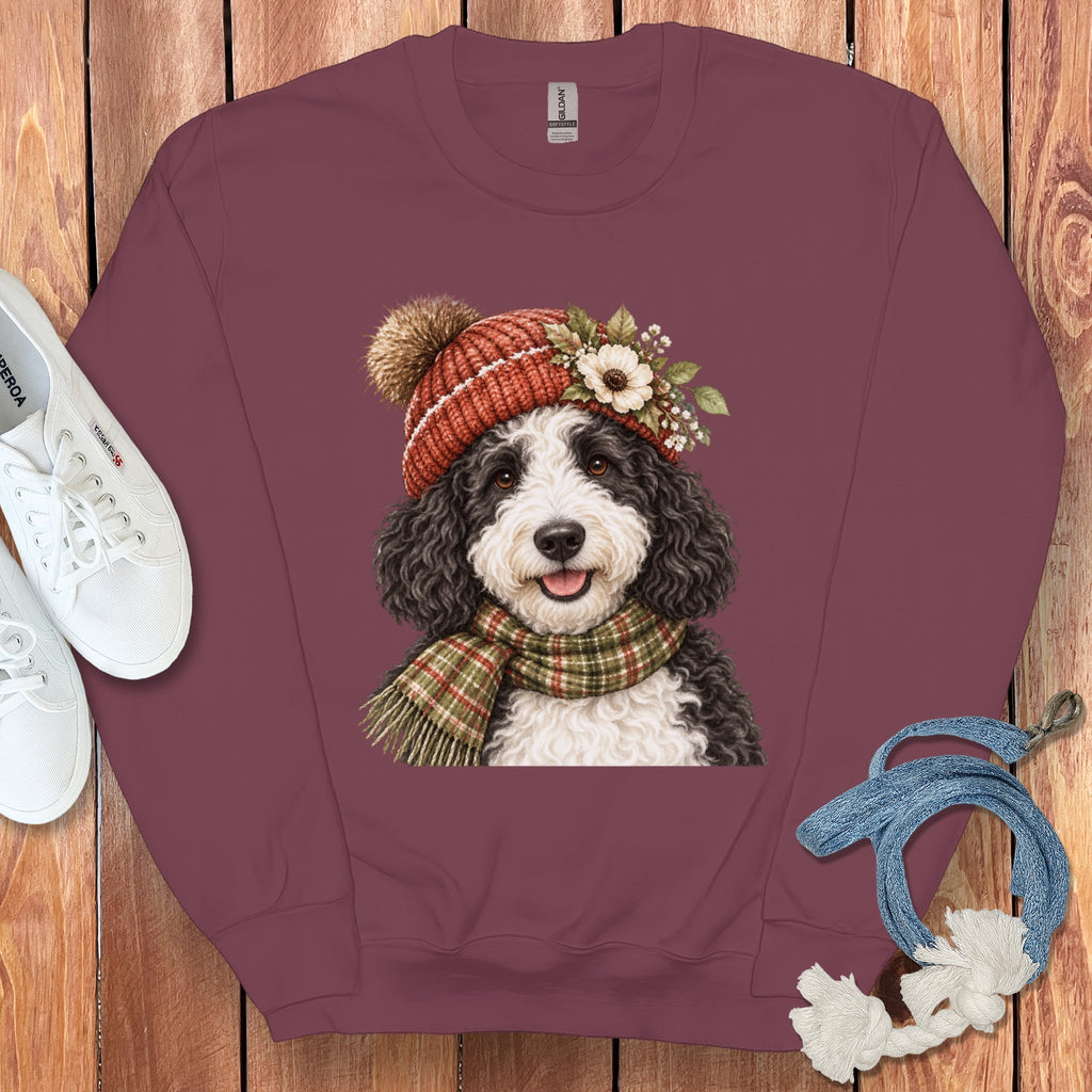 Maroon sweatshirt with a Bernedoodle dog wearing a hat and scarf graphic.