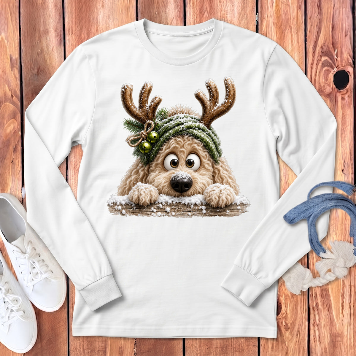 White long sleeve shirt with a fluffy dog wearing antlers and a green beanie.