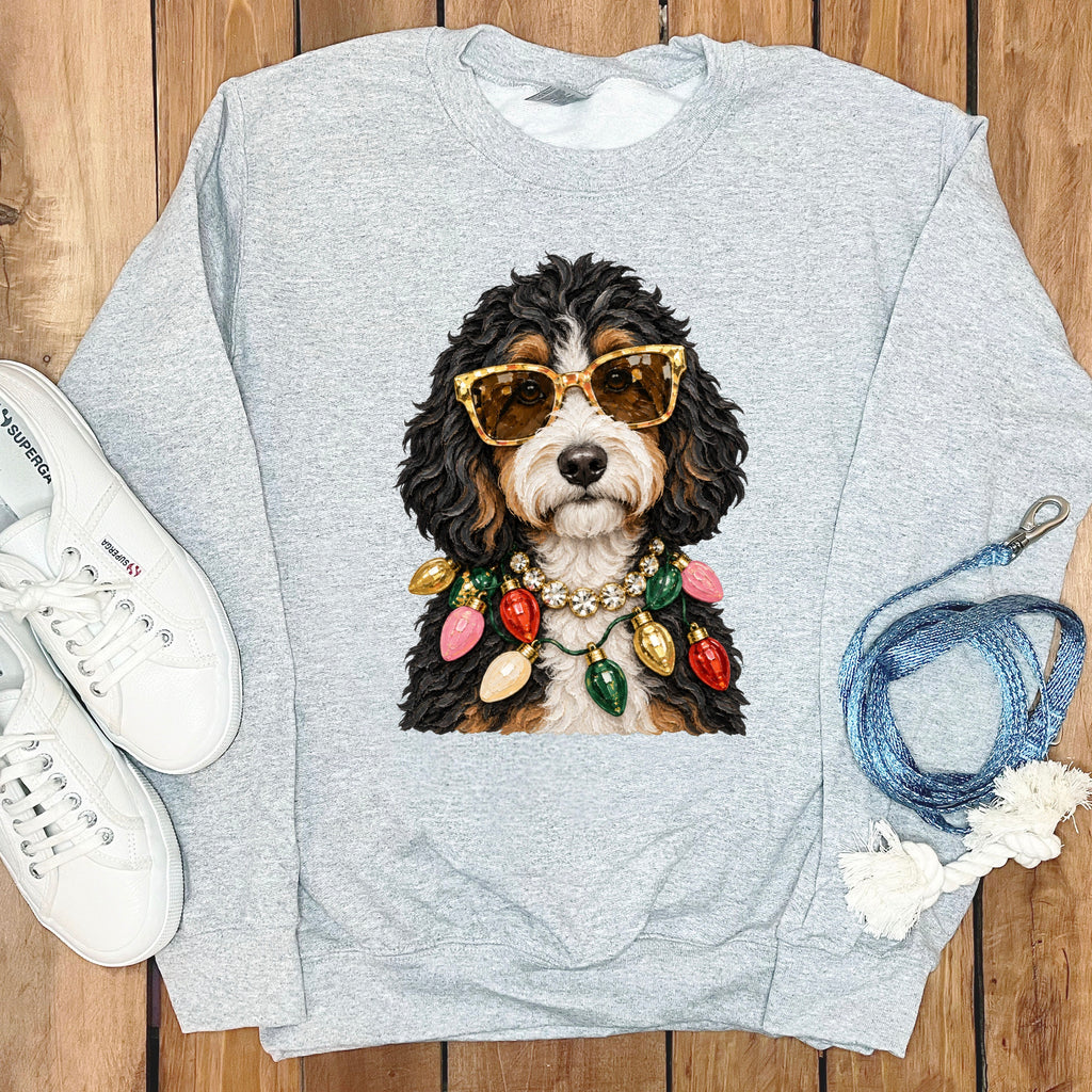 Light grey sweatshirt with a dog wearing sunglasses and Christmas lights.