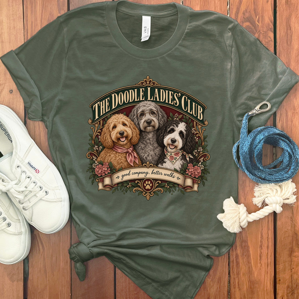 Olive t-shirt with "The Doodle Ladies Club" graphic of three dogs and "good company, better walks."
