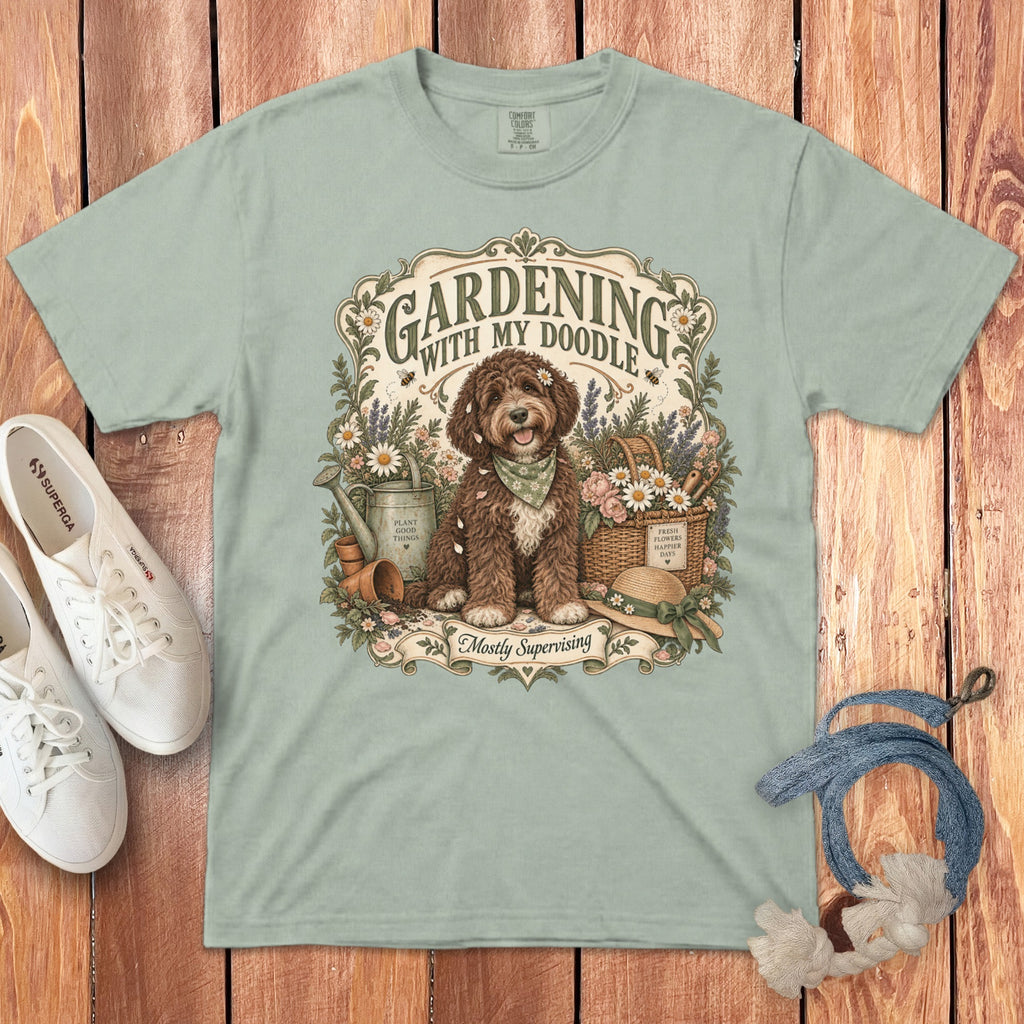 Light green t-shirt with a doodle dog gardening graphic and text "Gardening With My Doodle" and "Mostly Supervising".