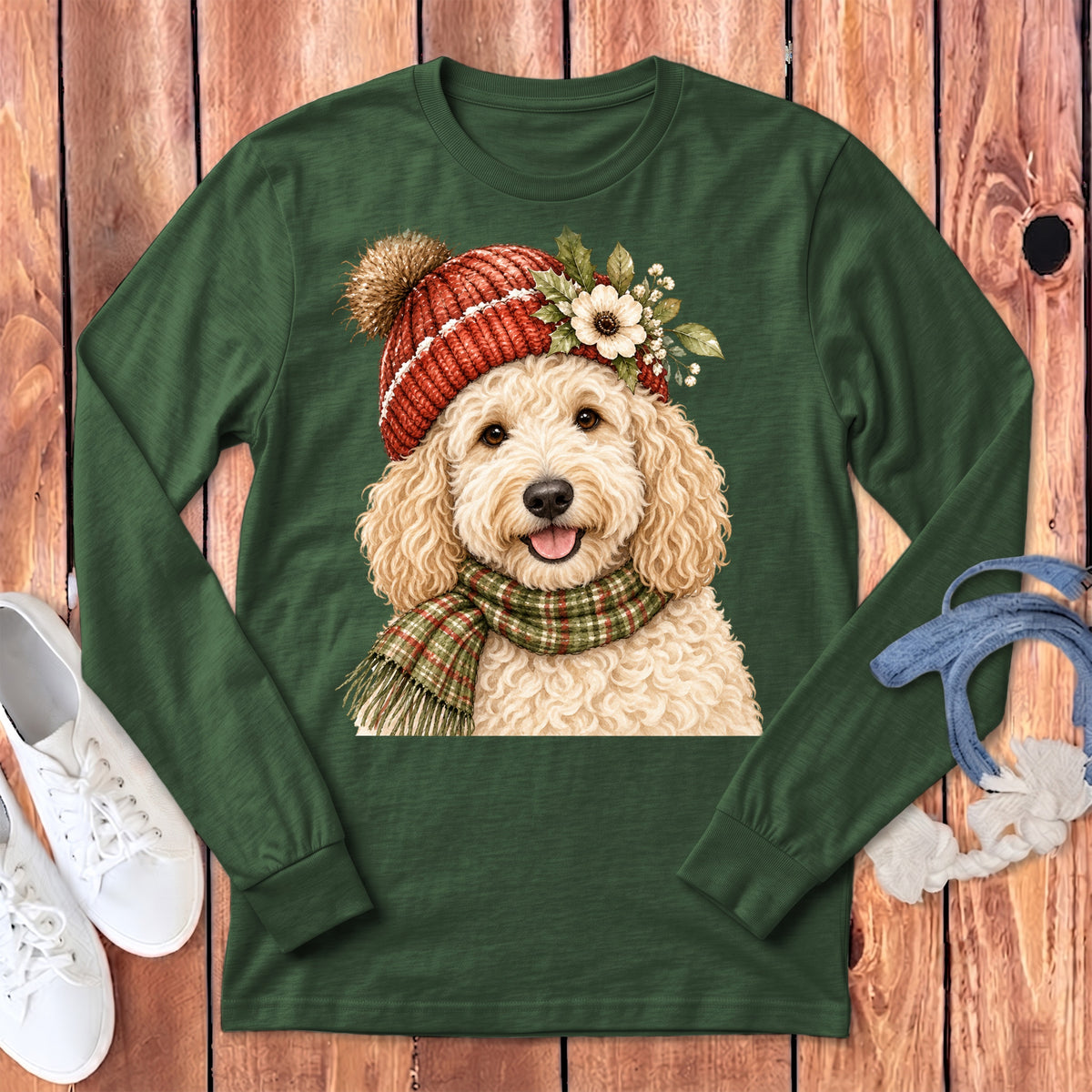 Green long-sleeve shirt with a watercolor doodle wearing a red beanie and plaid scarf.
