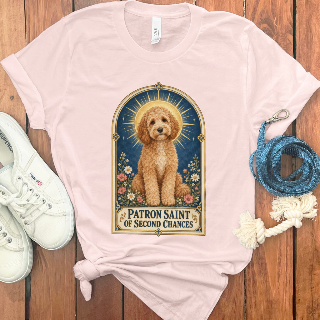 Pink t-shirt with a dog graphic that reads "Patron Saint of Second Chances."
