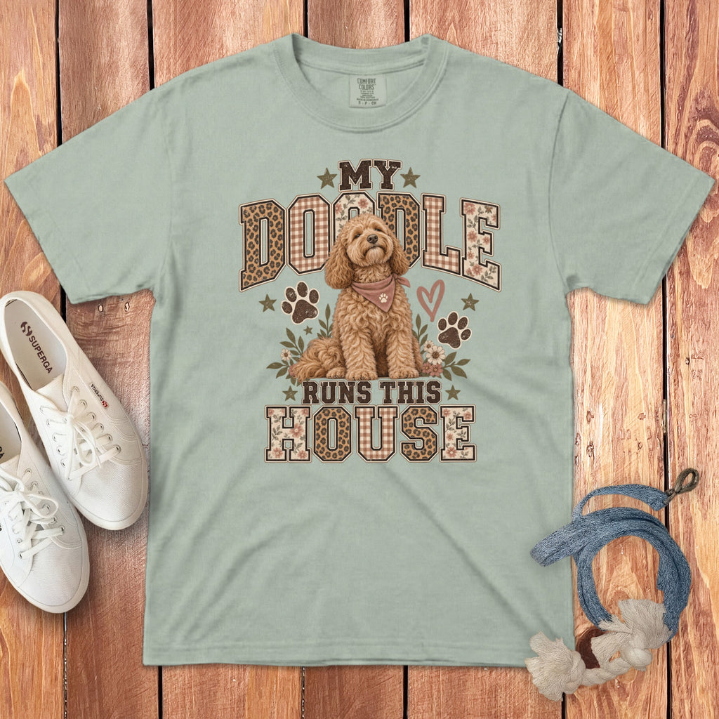 Sage green t-shirt with a graphic of a golden doodle and the text My Doodle Runs This House.