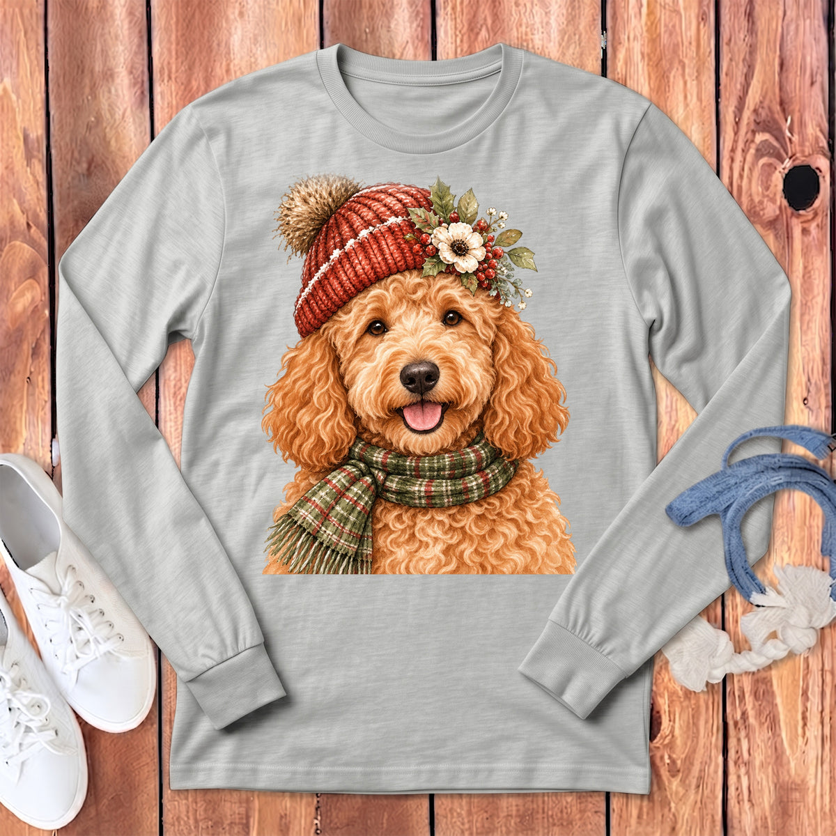 Light grey long-sleeved shirt with a watercolor doodle wearing a festive hat and scarf.