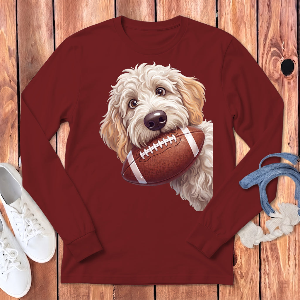 Maroon long-sleeved shirt featuring a fluffy golden retriever puppy holding a football in its mouth.