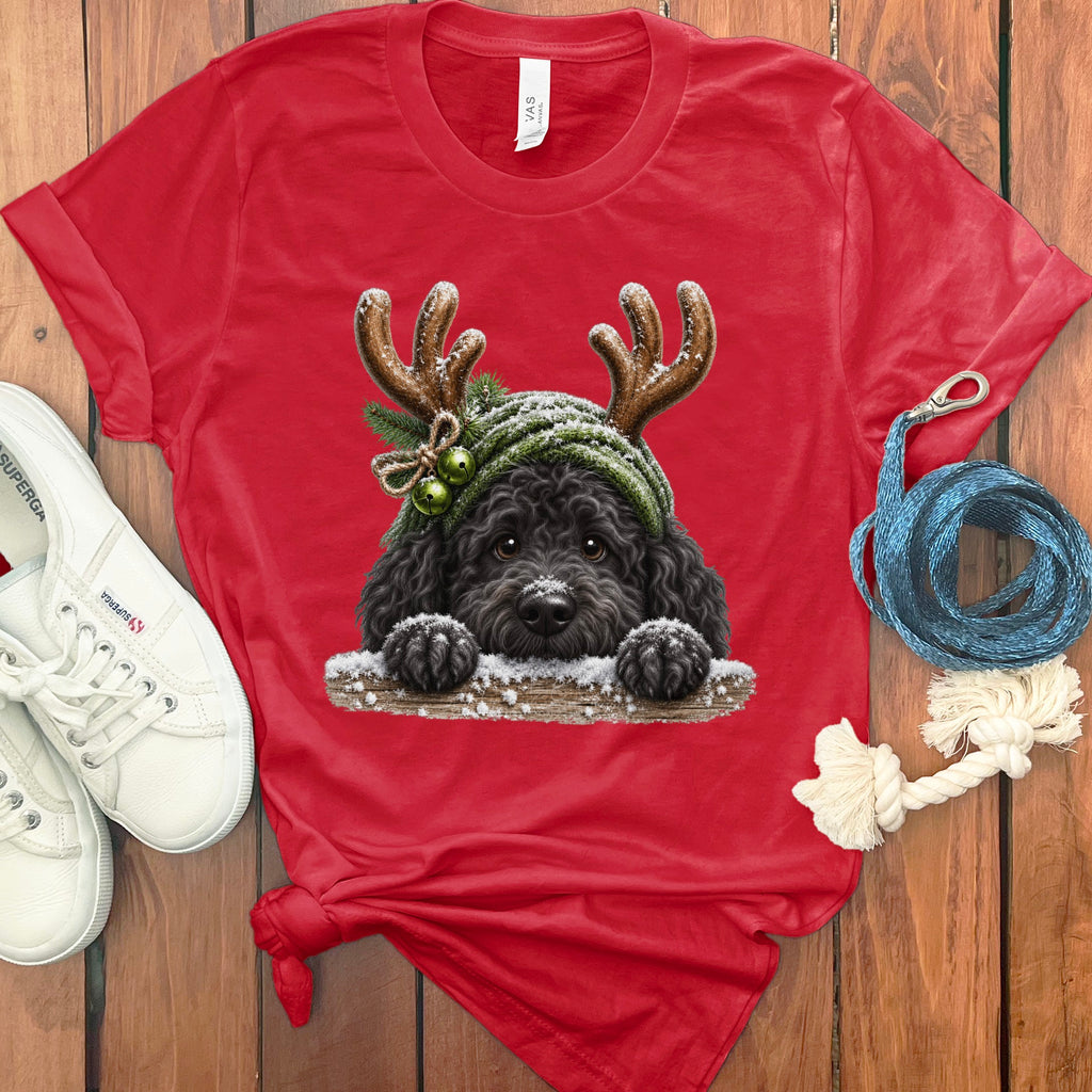 Red t-shirt with a black dog wearing reindeer antlers and a green hat.