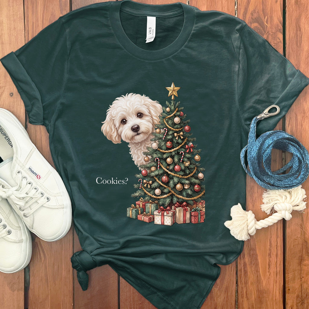 Dark green t-shirt with a fluffy white dog peeking from behind a Christmas tree and gifts.