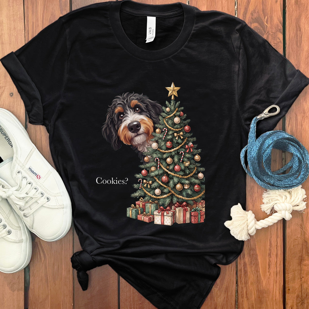 Black t-shirt with a dog peeking out from behind a Christmas tree.
