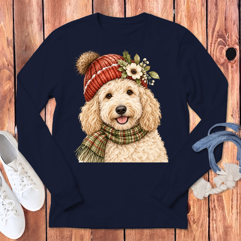 Goldendoodle wearing a red knit hat, scarf, and floral accents on a navy shirt.