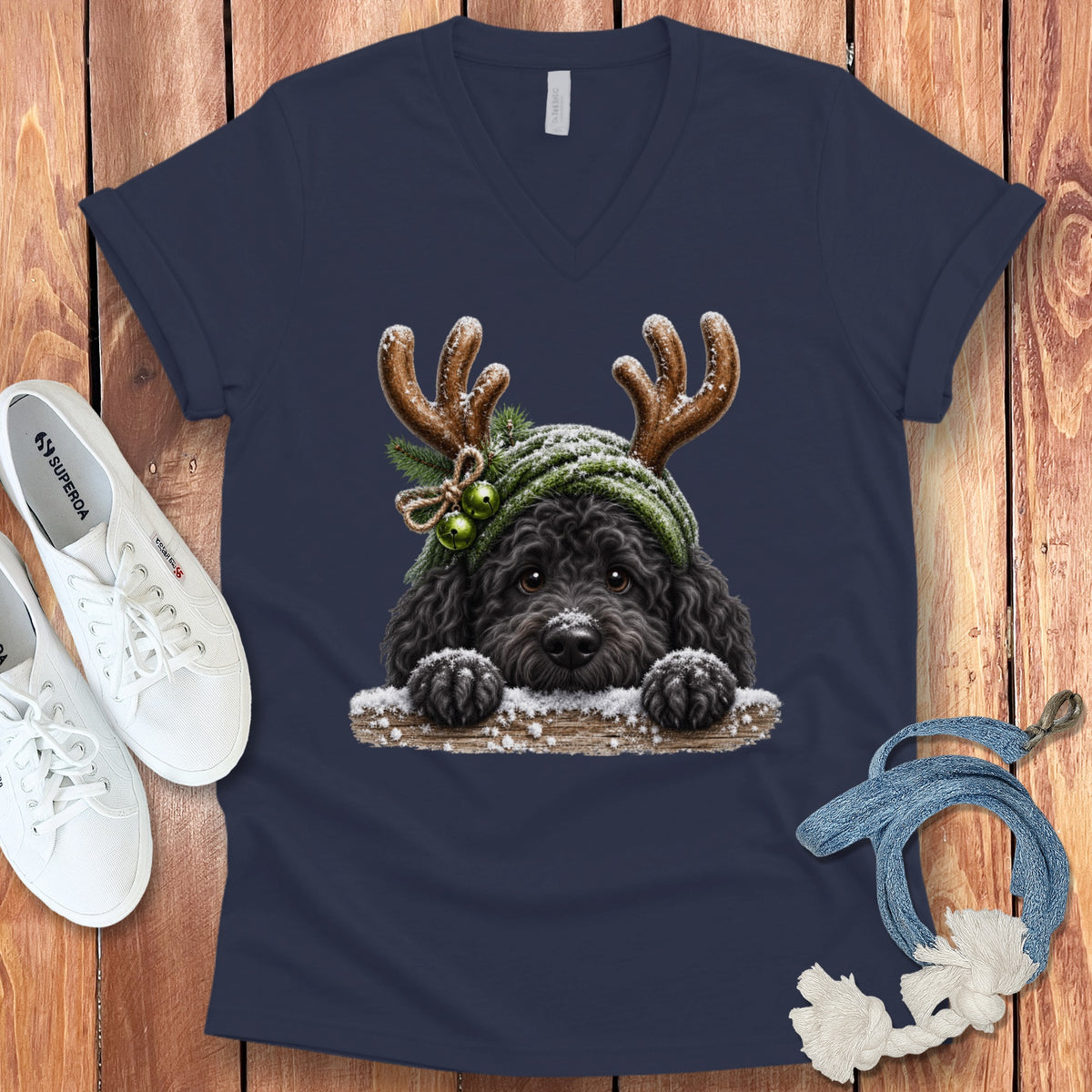 Black dog with antlers and green hat on navy t-shirt.