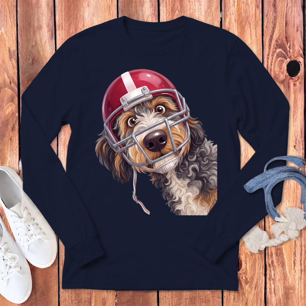 Dog wearing a red and white football helmet on a navy blue long-sleeve shirt.