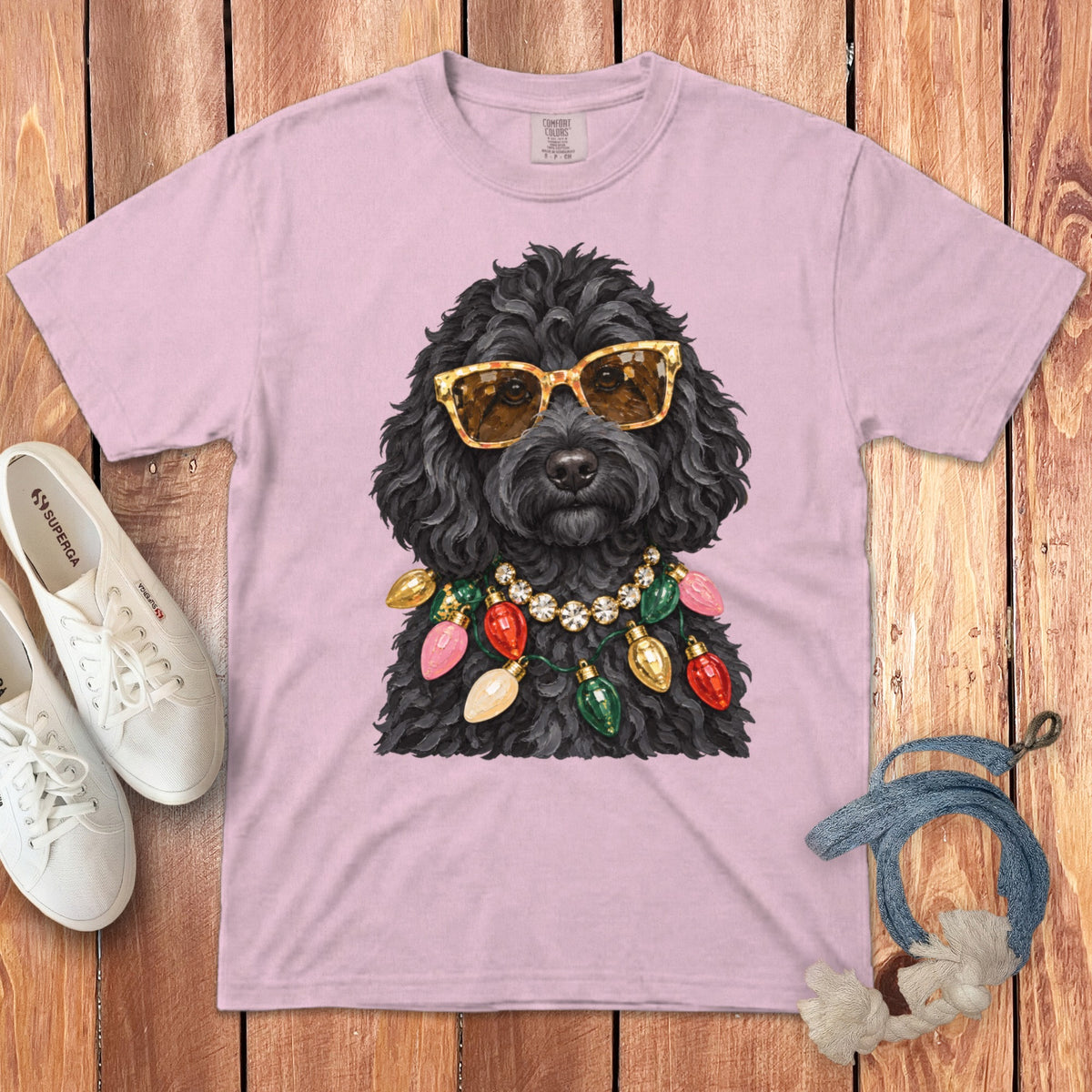Pink t-shirt with a black dog wearing sunglasses and a Christmas light necklace.