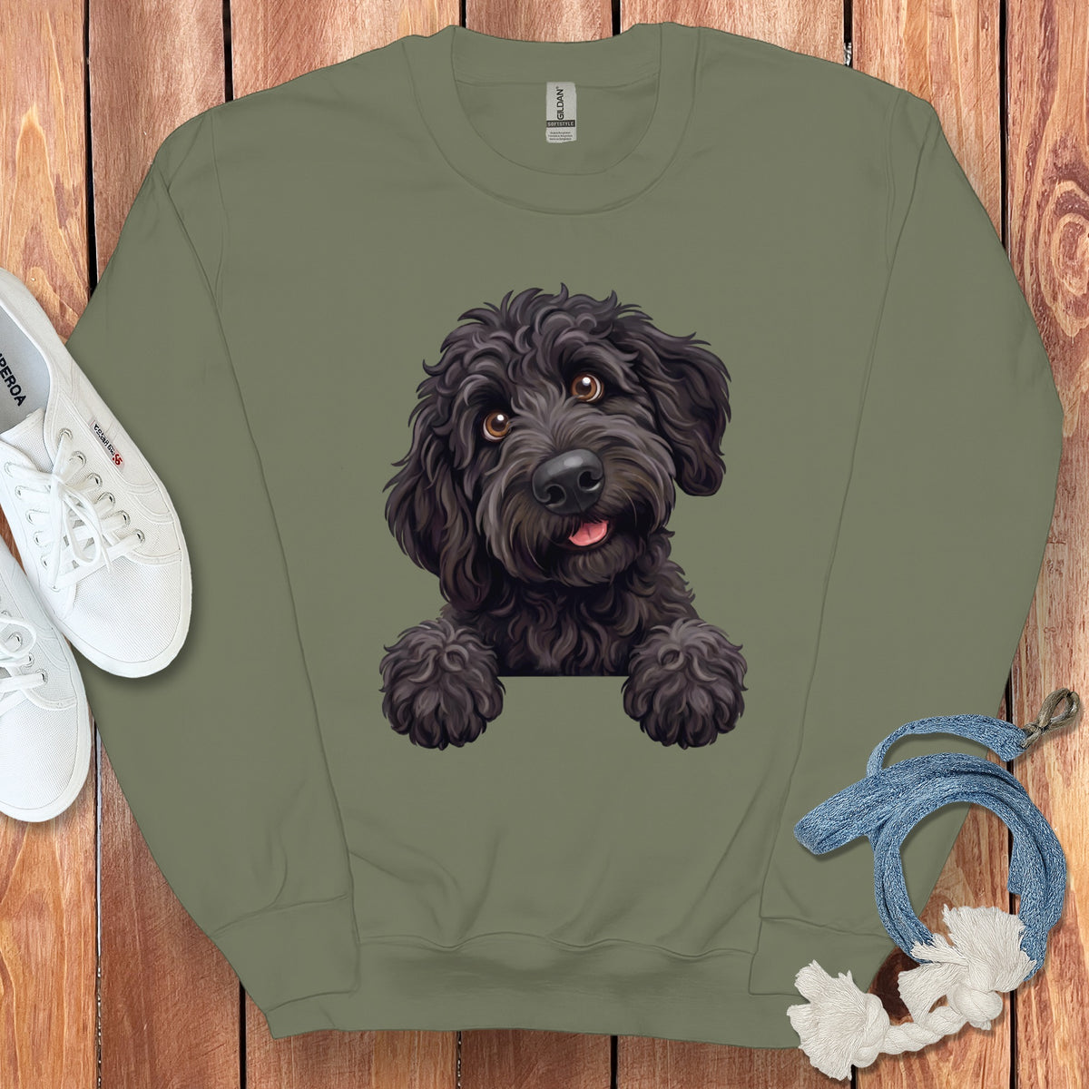 Olive green sweatshirt with a black doodle dog graphic and white sneakers.