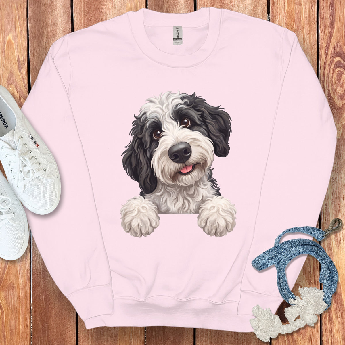 Pink sweatshirt with black and white dog graphic, white sneakers, and blue rope.