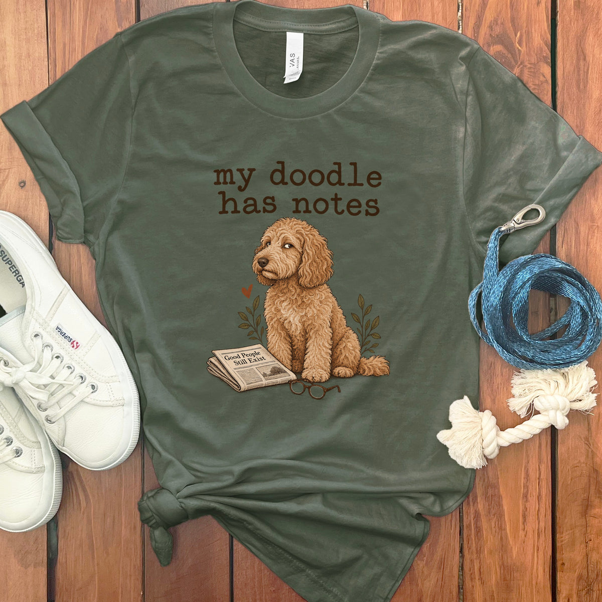 Green t-shirt with "my doodle has notes" and a doodle dog with newspaper and glasses.
