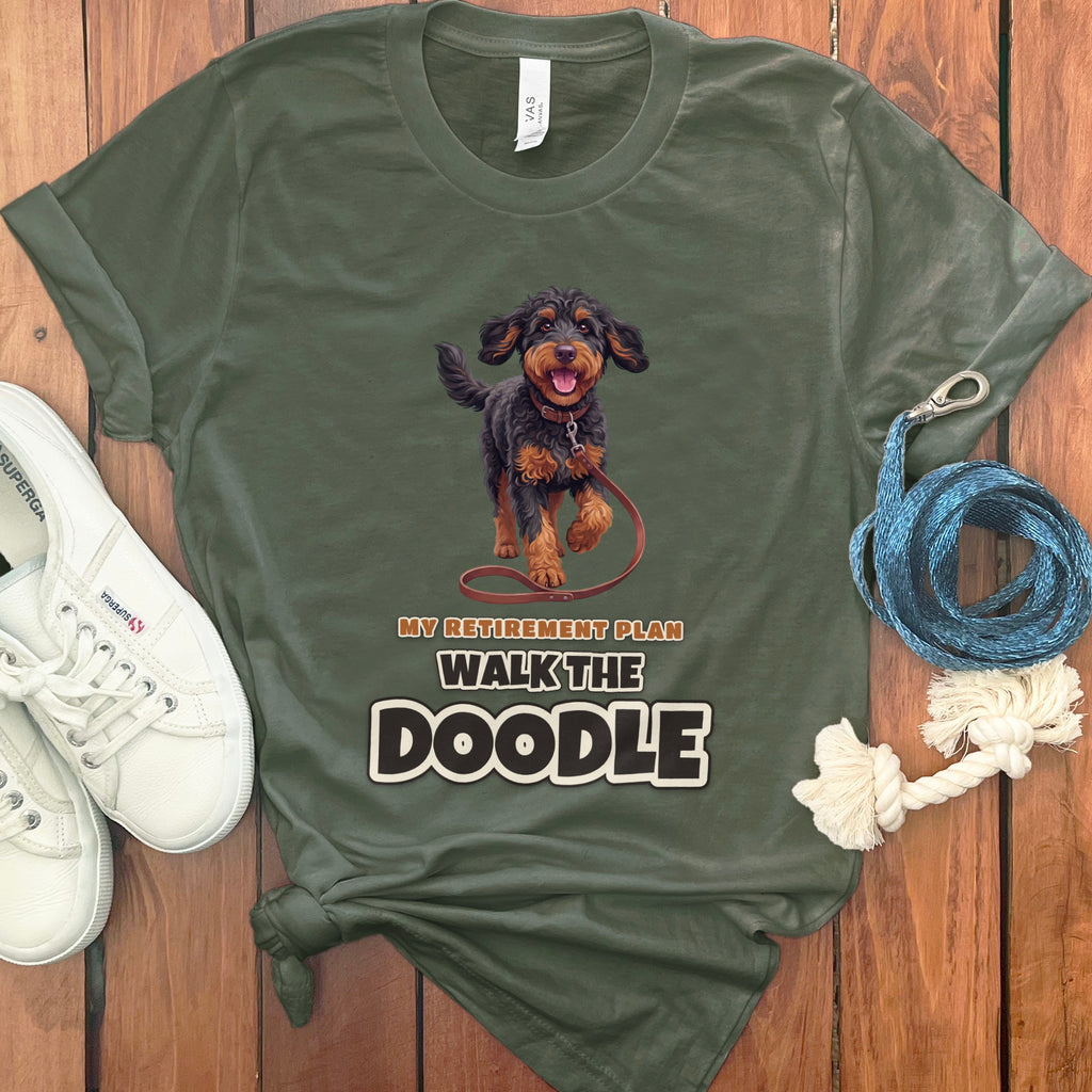 Green t-shirt with a doodle dog graphic and text: "MY RETIREMENT PLAN WALK THE DOODLE."