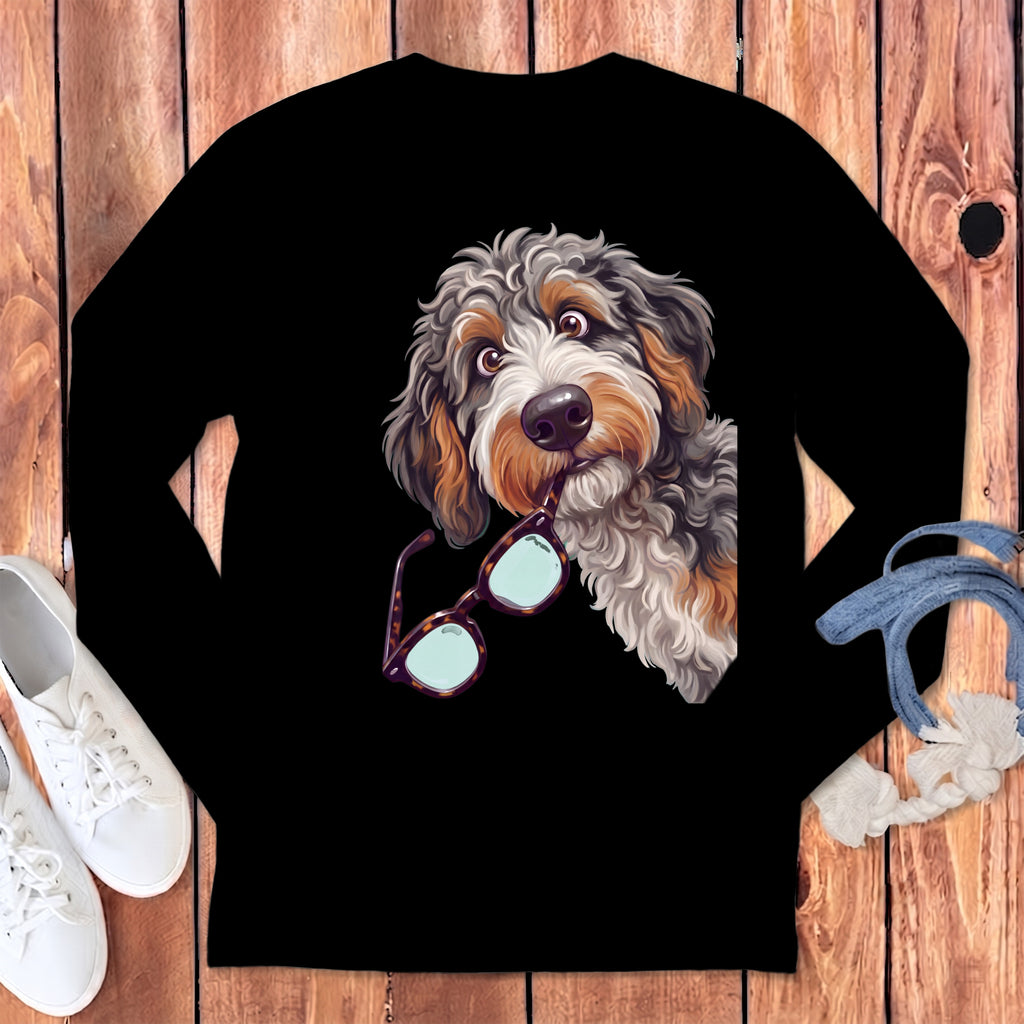 Black long-sleeved shirt featuring a colorful illustration of a fluffy dog holding glasses in its mouth.
