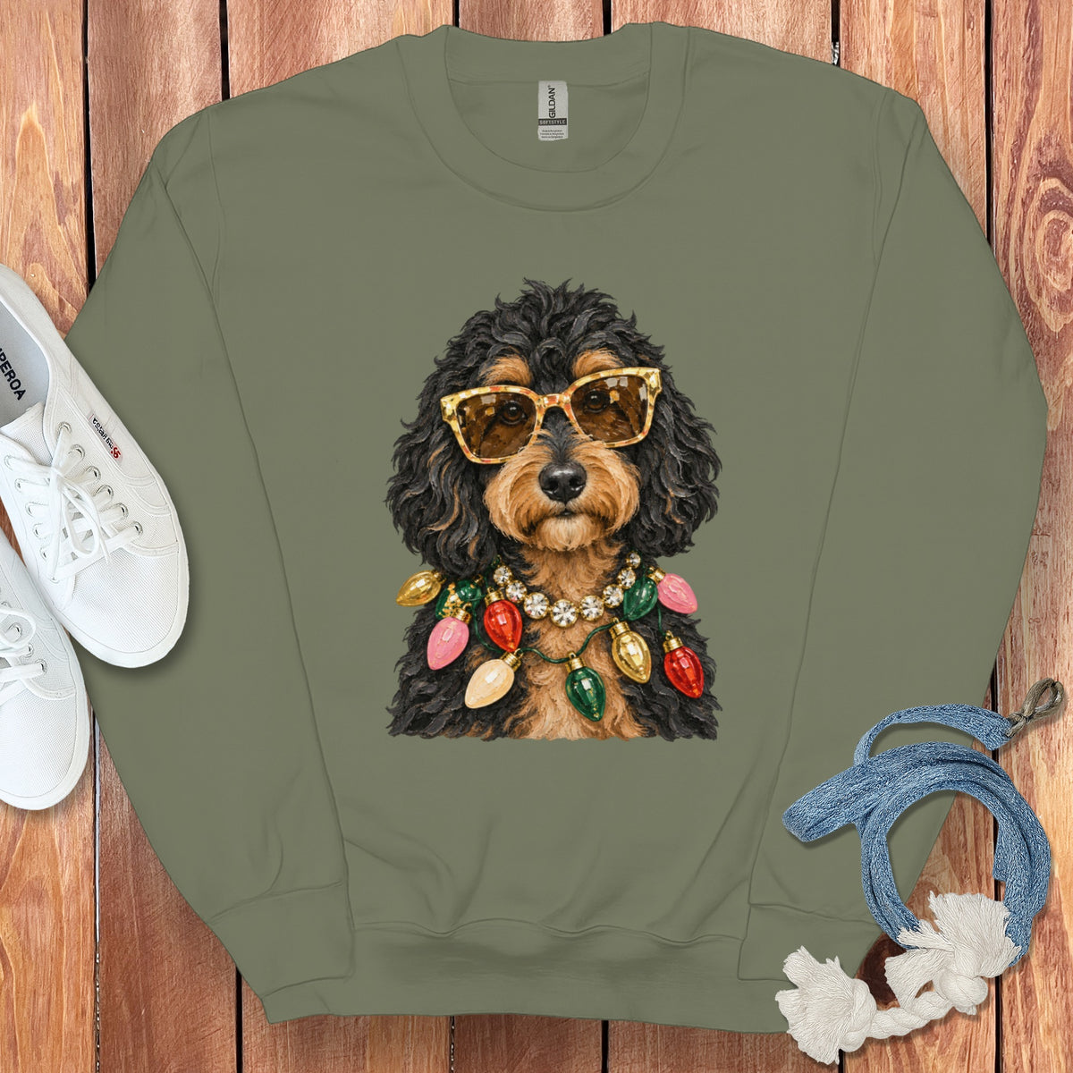 Crewneck sweatshirt with a black and tan dog wearing sunglasses and Christmas lights.