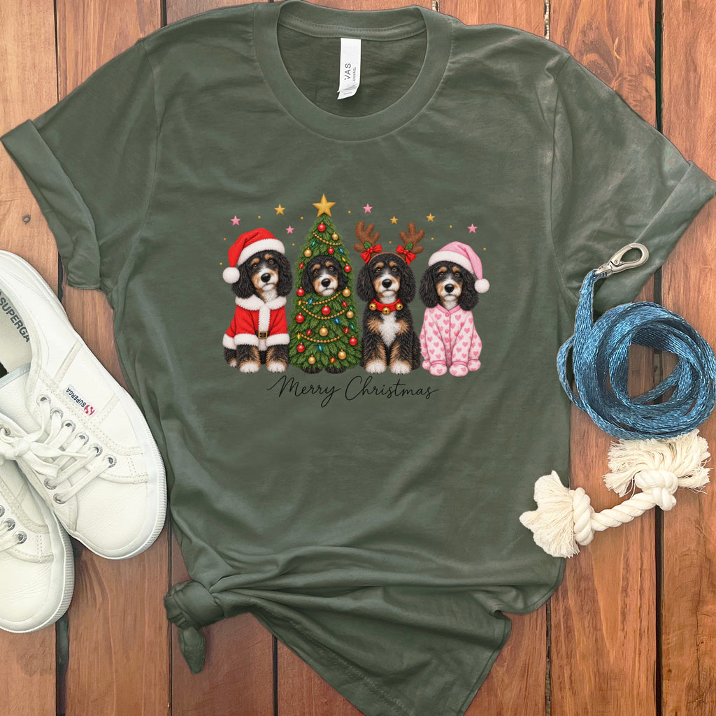Dark green t-shirt featuring a graphic of four dogs celebrating Christmas with the text Merry Christmas.