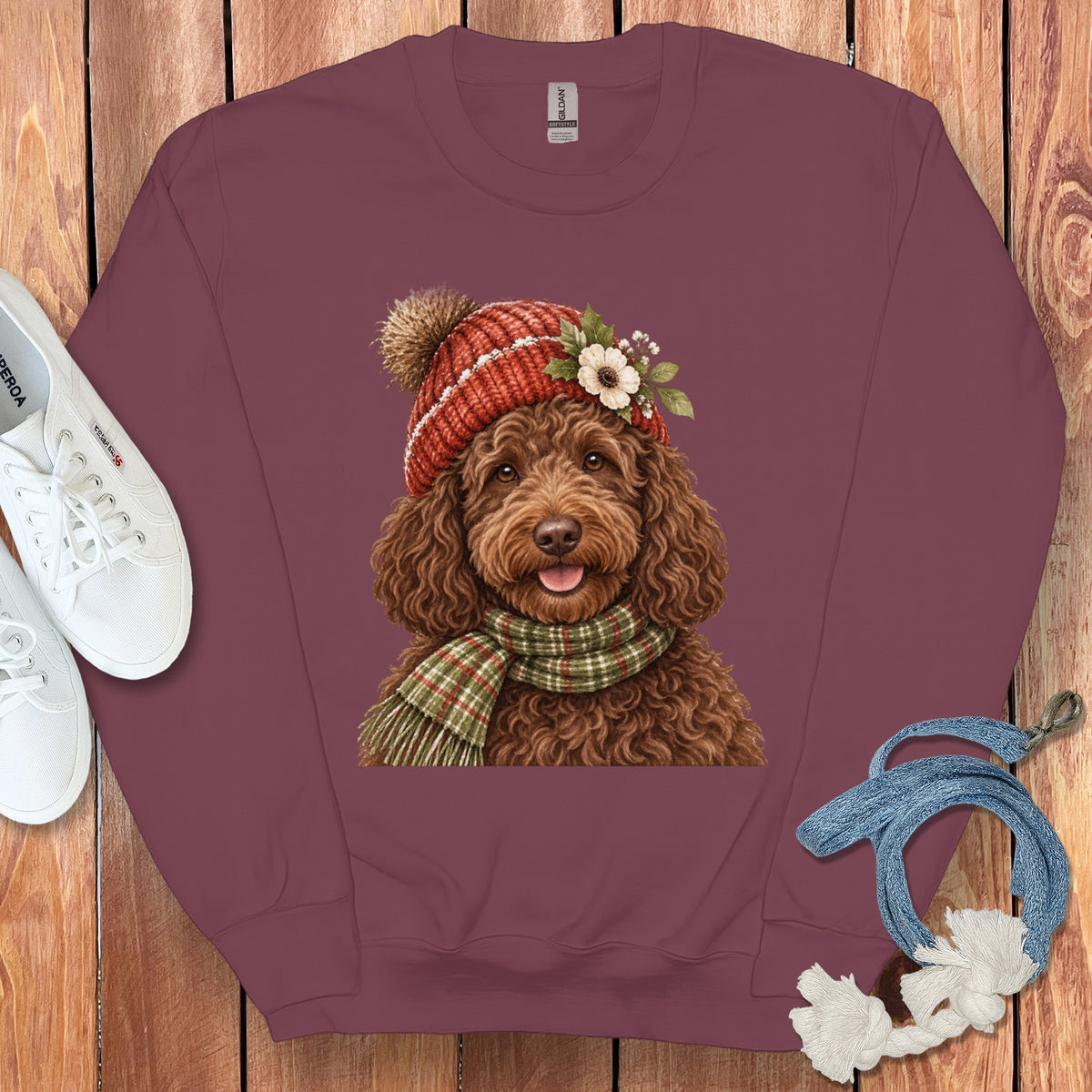 Brown doodle dog wearing a red knit hat and plaid scarf.