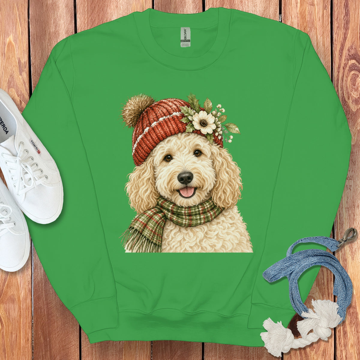 Green sweatshirt with a watercolor illustration of a fluffy dog wearing a hat and scarf.