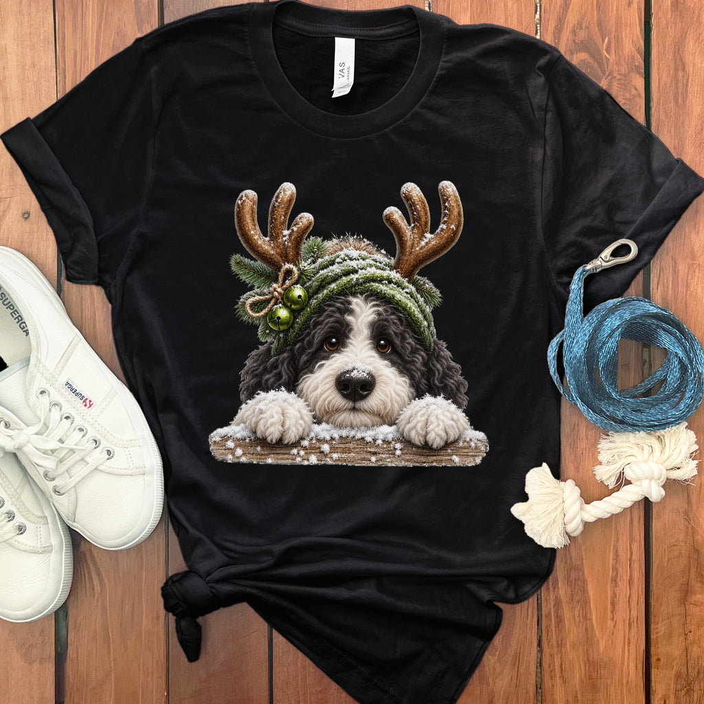 Black t-shirt with a Christmas dog graphic wearing reindeer antlers and a knit hat.