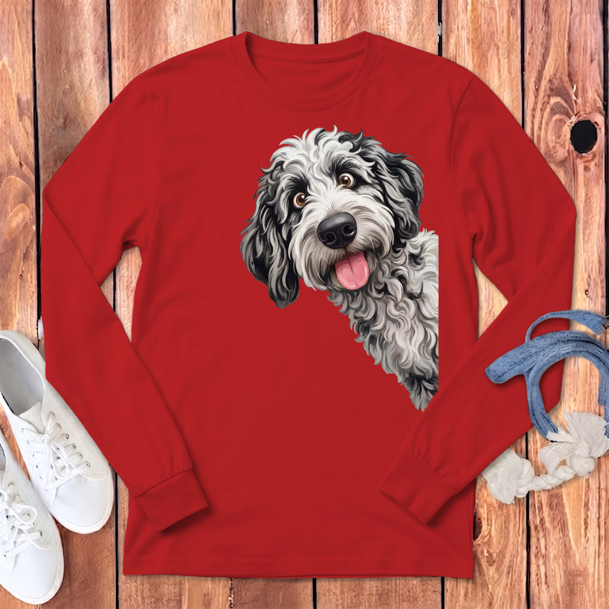 Red long sleeve shirt with a black and white fluffy dog peeking out.