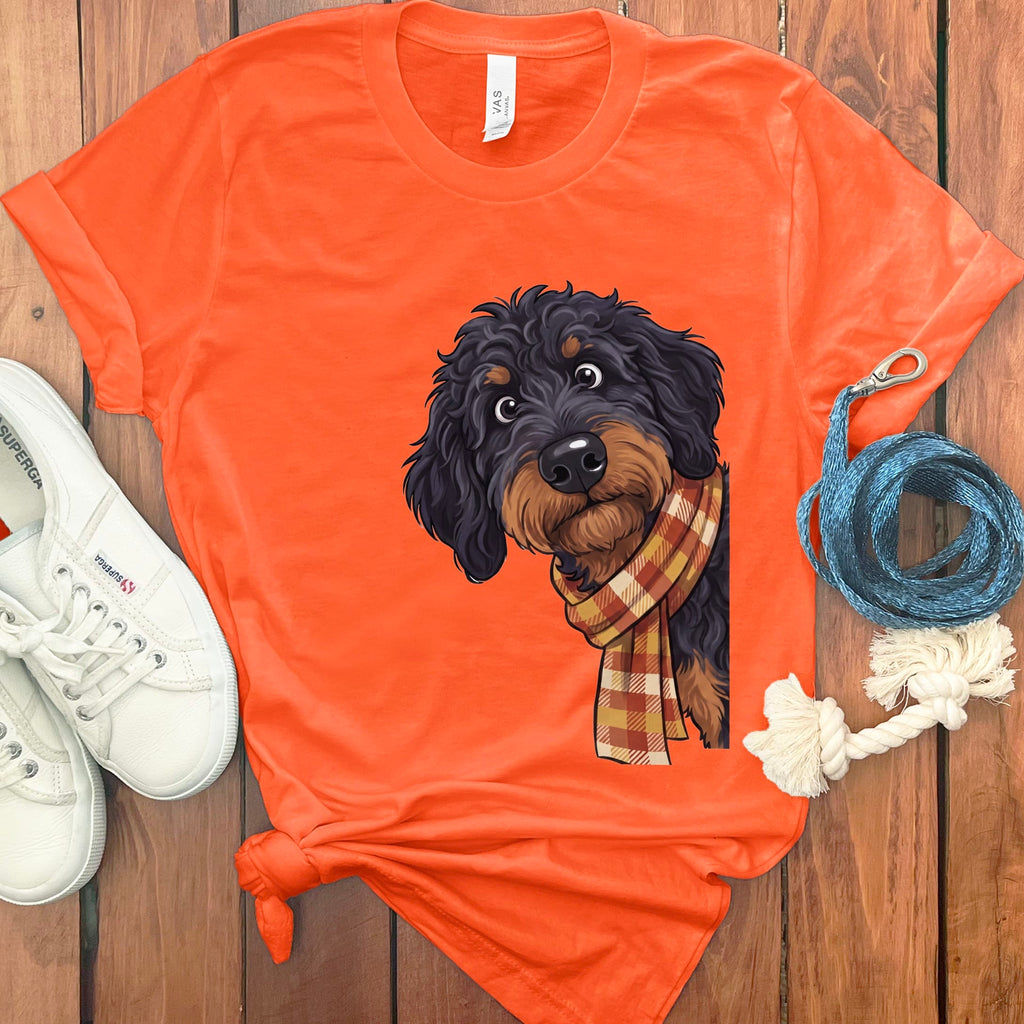 Orange t-shirt with a scruffy dog wearing a plaid scarf graphic.