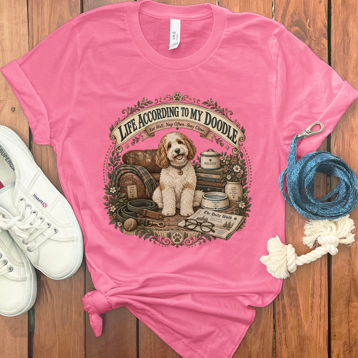 Pink t-shirt with a doodle dog, books, and the text "Life According to My Doodle."