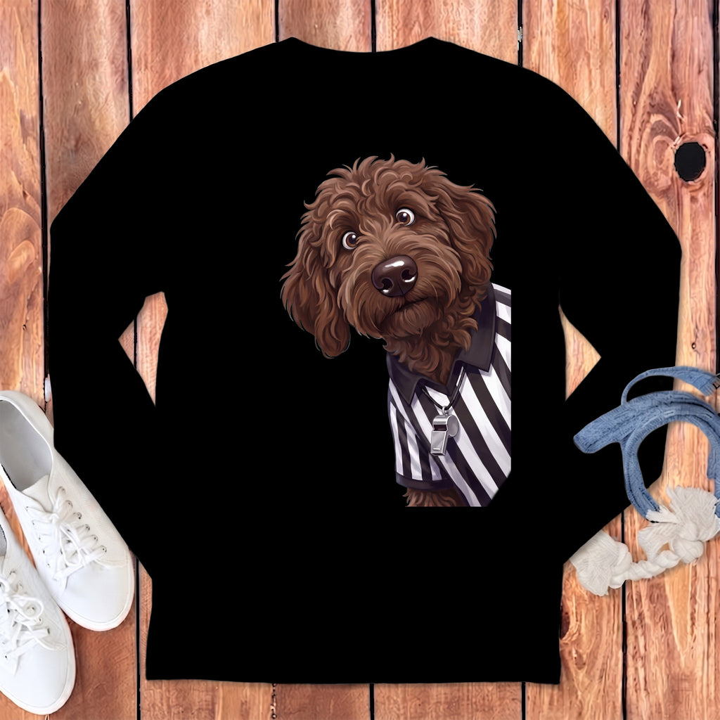 Brown doodle dog wearing a referee shirt and whistle on black long sleeve shirt.