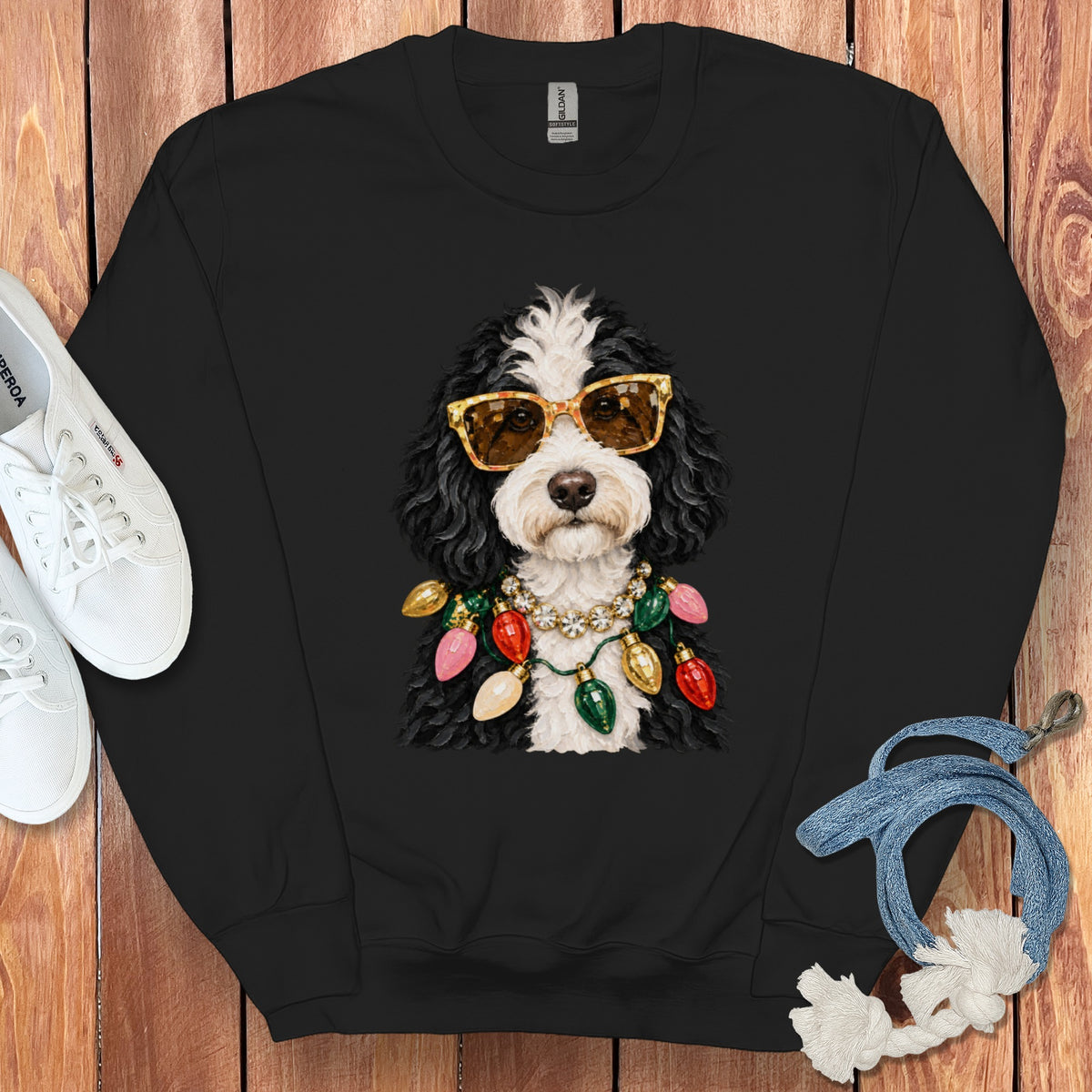 Black sweatshirt featuring a dog wearing sunglasses and a string of Christmas lights.