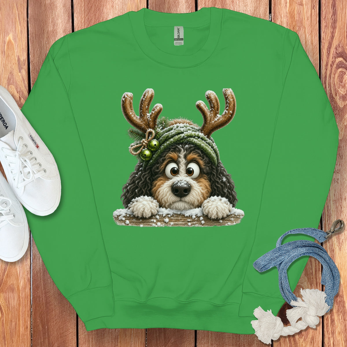 Green sweatshirt with a cartoon dog wearing antlers and a hat.