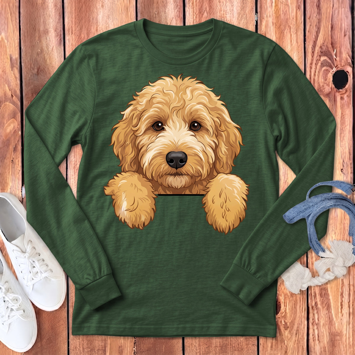 Green long-sleeve shirt with cartoon goldendoodle dog peeking over pocket.