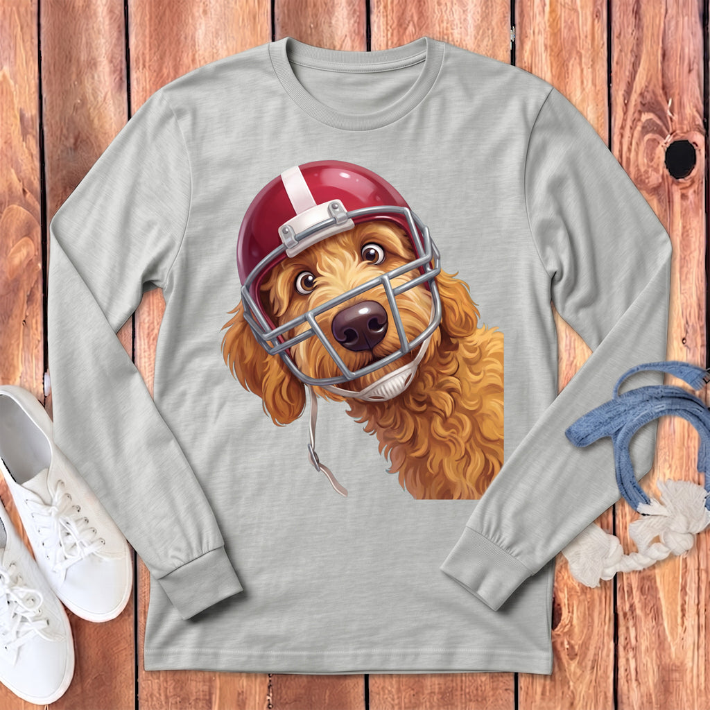Golden doodle wearing a red and white football helmet on a grey long-sleeved shirt.