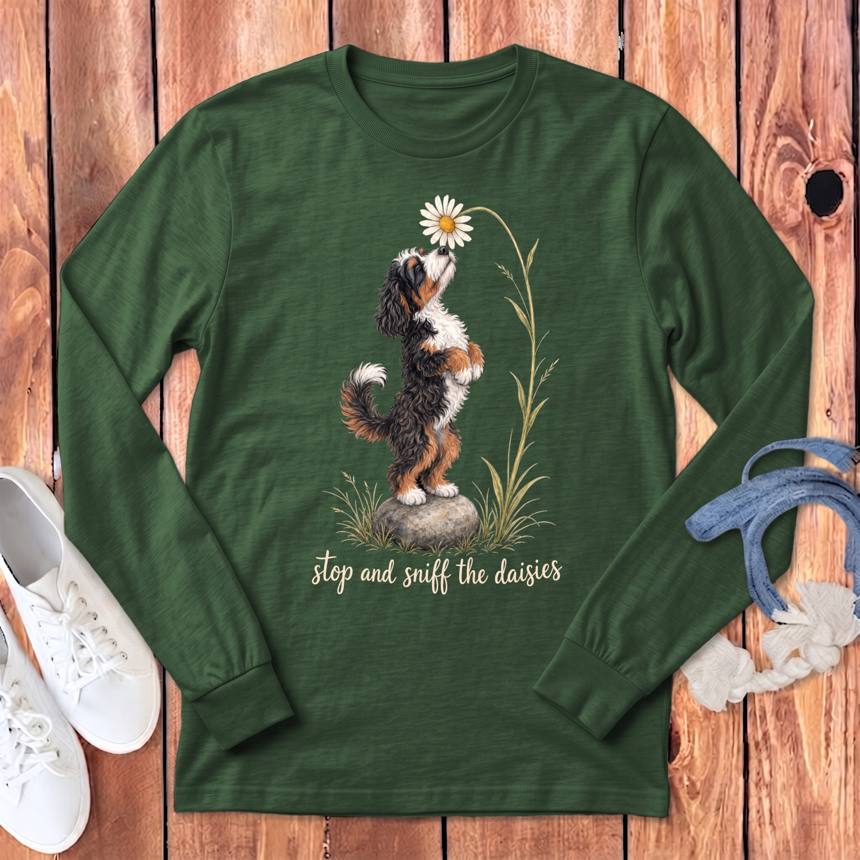 Bernese Mountain Dog smelling a daisy with text "stop and sniff the daisies".