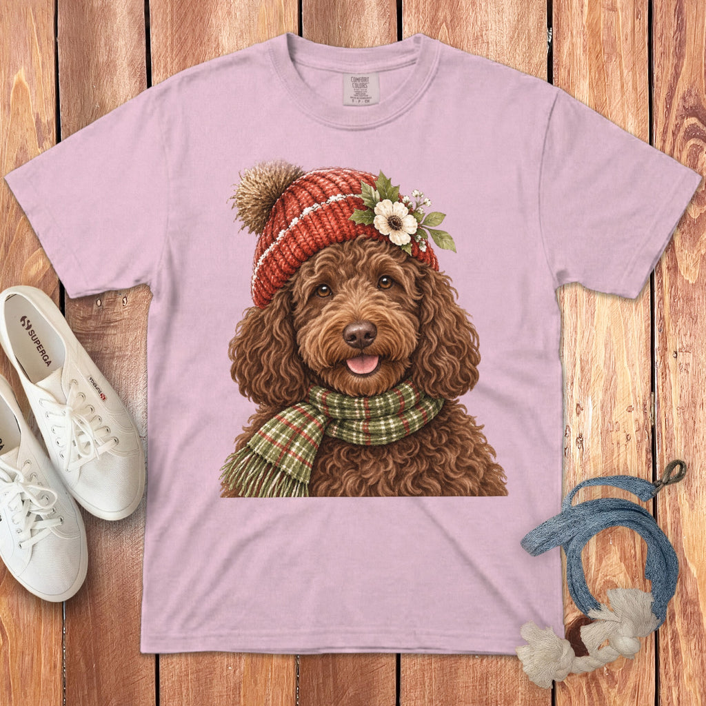 Brown poodle wearing a knitted hat and scarf, with a flower detail.