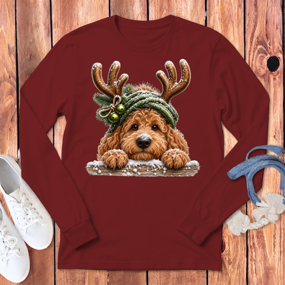 Maroon long sleeve shirt featuring a doodle dog wearing reindeer antlers and a knit hat.