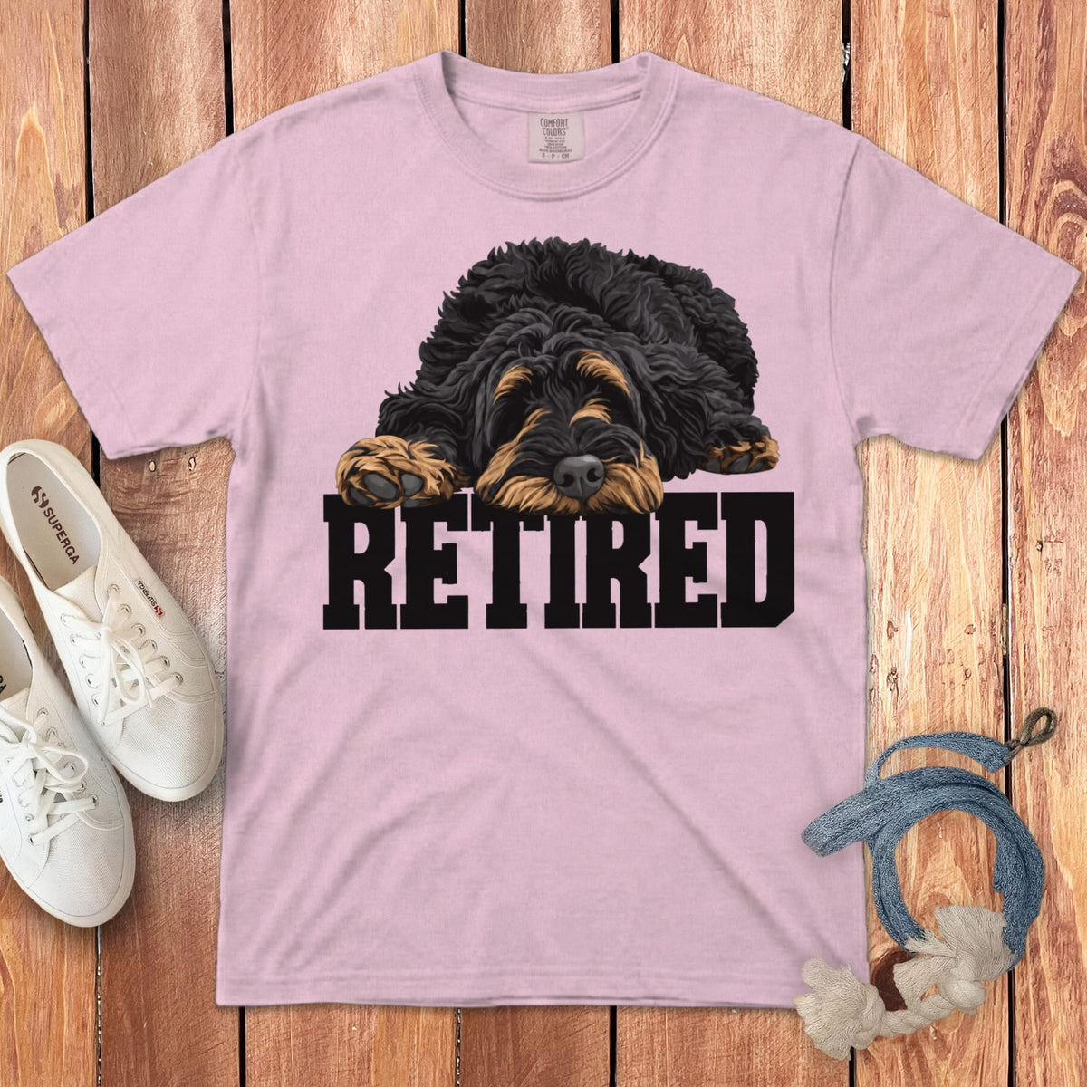 Pink t-shirt with a black and tan doodle dog illustration and the word "RETIRED".