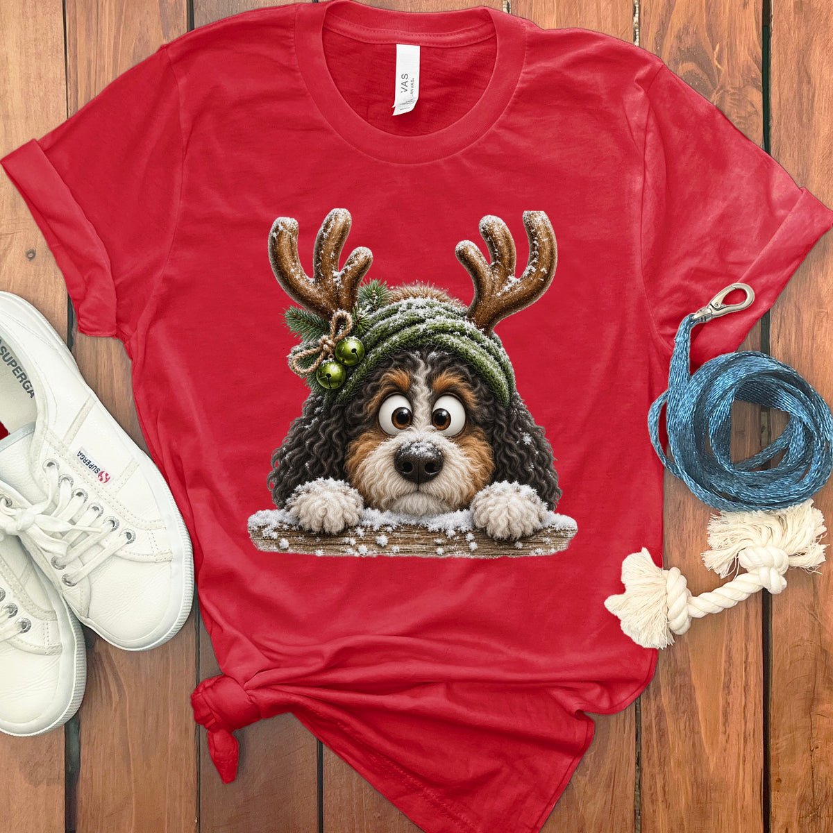 Red t-shirt with a cartoon dog wearing reindeer antlers and a beanie.