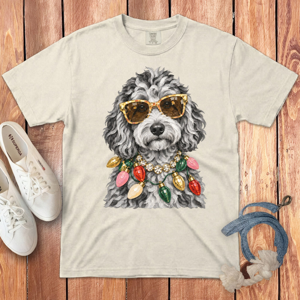 Cream t-shirt with a graphic of a poodle wearing sunglasses and Christmas lights.
