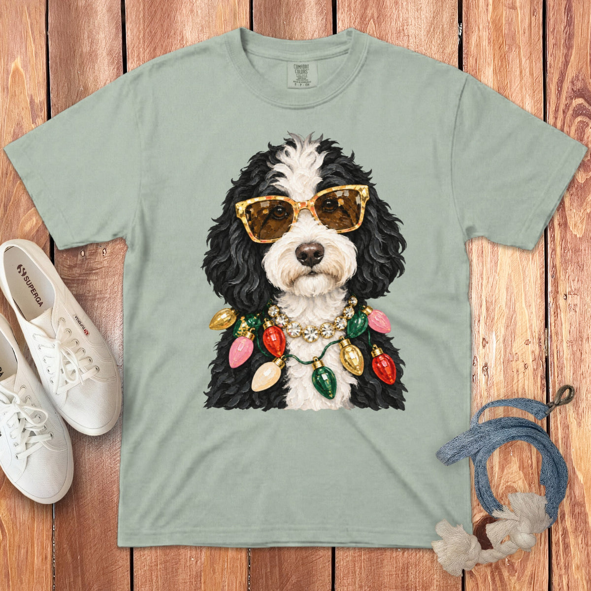 T-shirt with a dog wearing sunglasses and a Christmas light necklace.